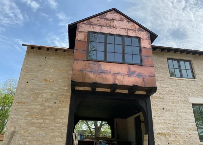 Copper metal panel facade on a stone building for Skylight Installation in Litchfield